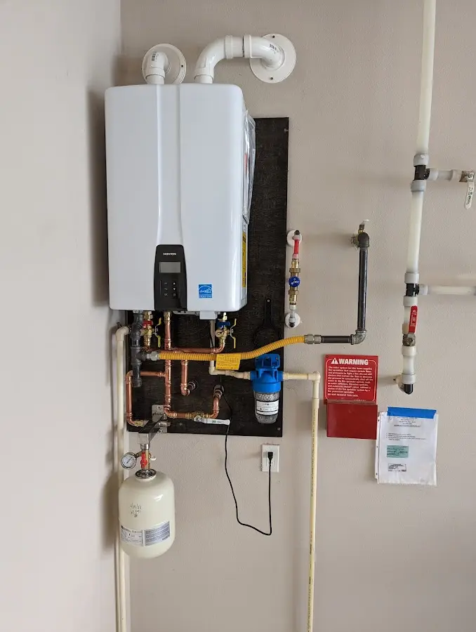 Professional plumber installing copper piping in a Fort Kent home